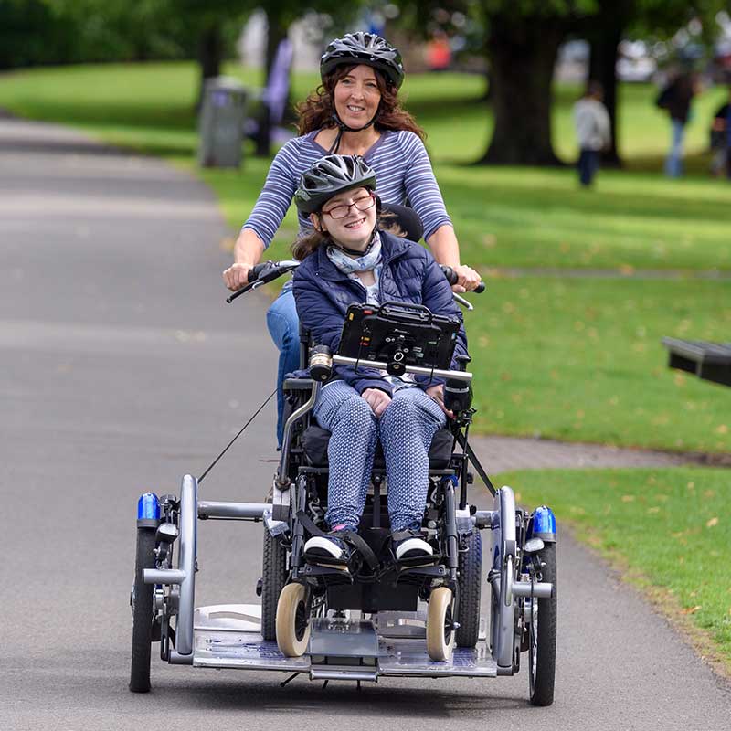 Accessible bike with wheelchair user and pilot