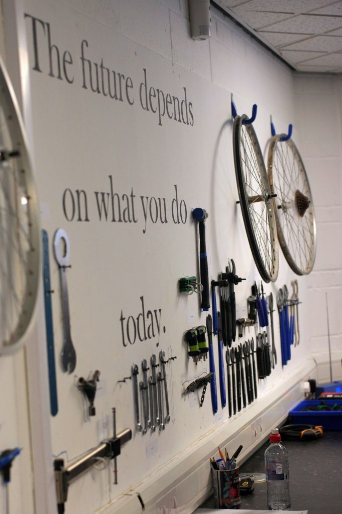 Photo of a shadow board of bike tools made by Access to Bikes Pupils. Quote on the wall says "The Future Depends on what you do today"